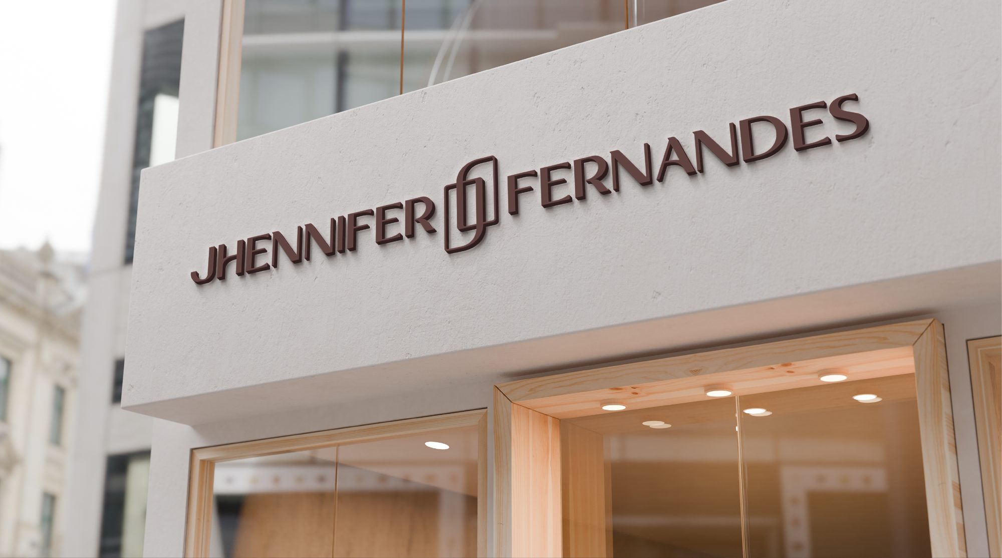 Mockup de fachada com o logotipo Jhennifer Fernandes em letras marrons.